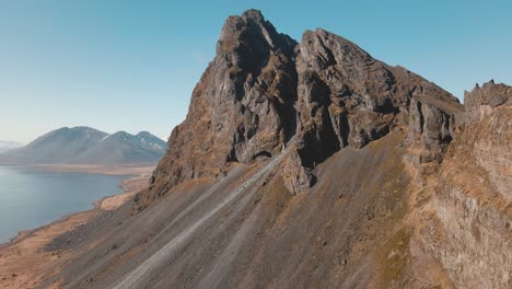 Big-mountain-with-a-orange-lighthouse-in-the-foreground