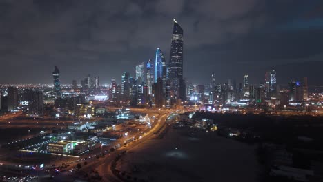 Night-cityscape,-illuminated-and-flashing-lights-skyscrapers