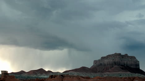 lightning flashes from storm clouds over goblin valley state park