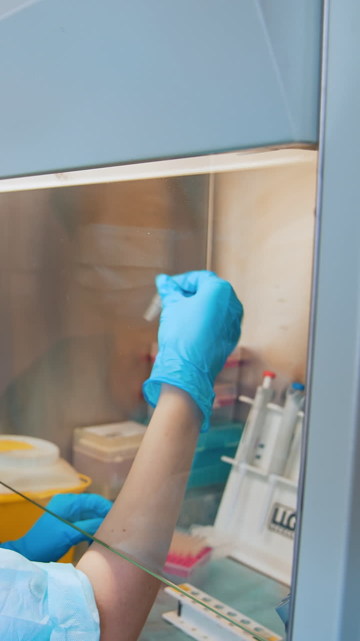 Technician hand holding collection tubes. Portrait of medical worker holding sample test kit. Vertical video