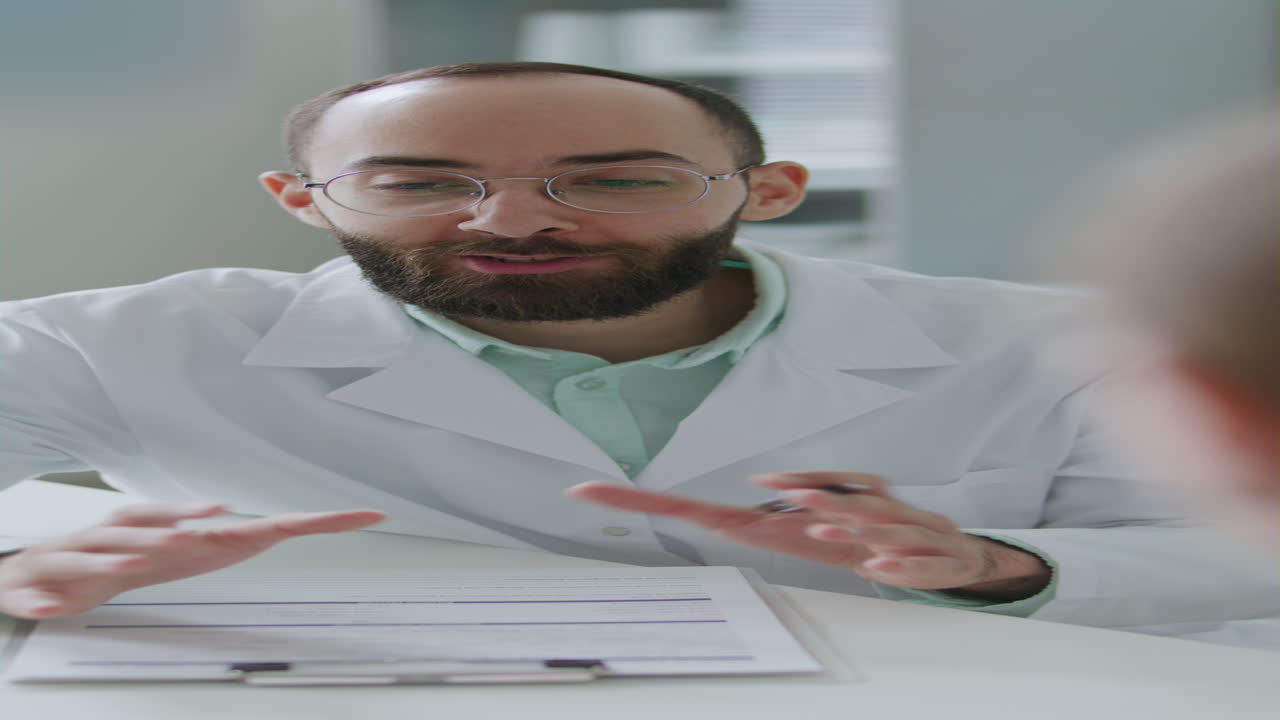 Smiling Doctor Discussing Health Information with Patient in Clinic