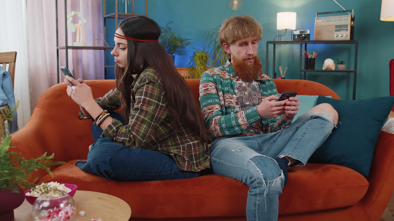 Family marriage couple man woman using smartphones after argument quarrel at home, ignore each other