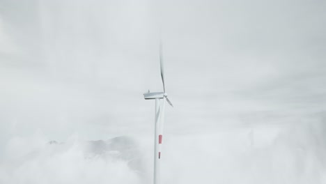 wind turbine in foggy mountain landscape