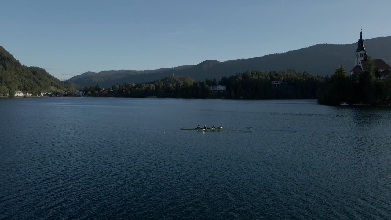 Scenic Lake Bled with autumn hues, rowers, and church island, Slovenia