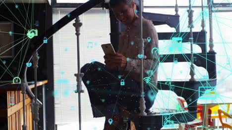 animation of connected icons globes, biracial woman sitting on staircase and scrolling on cellphone