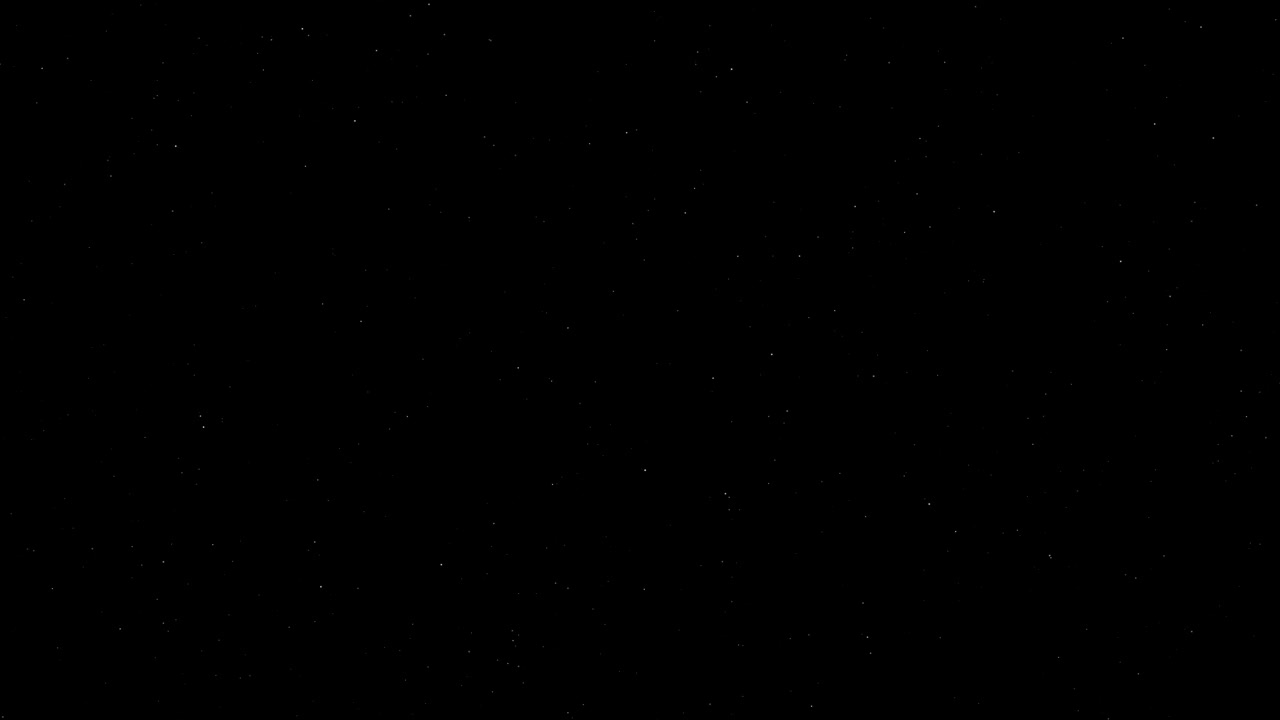 Sutiles partículas de estrellas blancas se desplazan horizontalmente sobre un fondo negro con un suave movimiento de cámara.