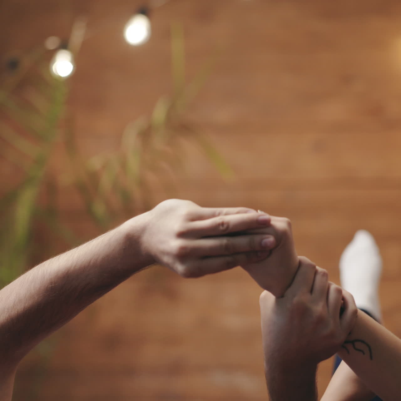Man's hands and two female's hands making gestures trying to catch each other. Arms of loving couple playing together on romantic background. Love concept