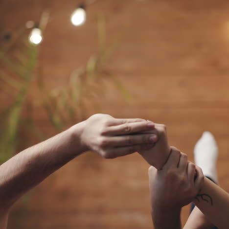 Man's hands and two female's hands making gestures trying to catch each other. Arms of loving couple playing together on romantic background. Love concept