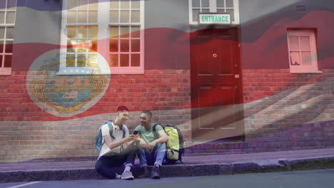 sitting on sidewalk with backpacks, two people under costa rica flag animation