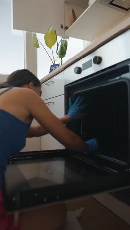 woman cleaning oven