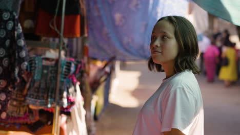 Slow-motion-bokeh-shot-of-a-female-tourist-looking-at-the-markets-in-Chiang-Mai