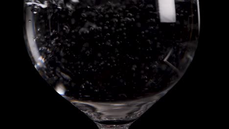 water burst in a red wine glas