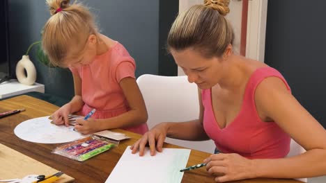 mother and daughter drawing together