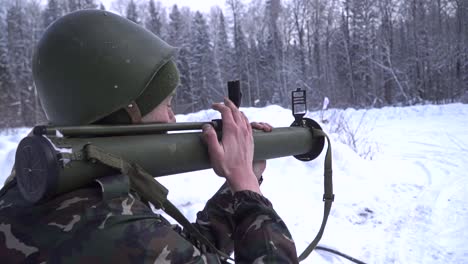 soldier with a grenade launcher in a snowy forest