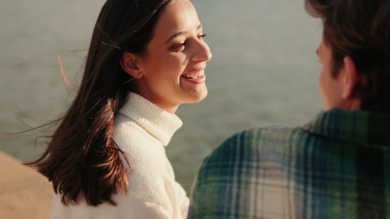 Young Couple Enjoys Sunset by the River