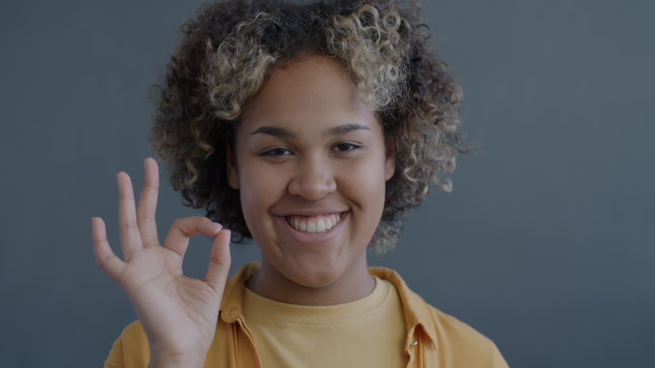 Happy Woman Smiling and Showing Ok Sign