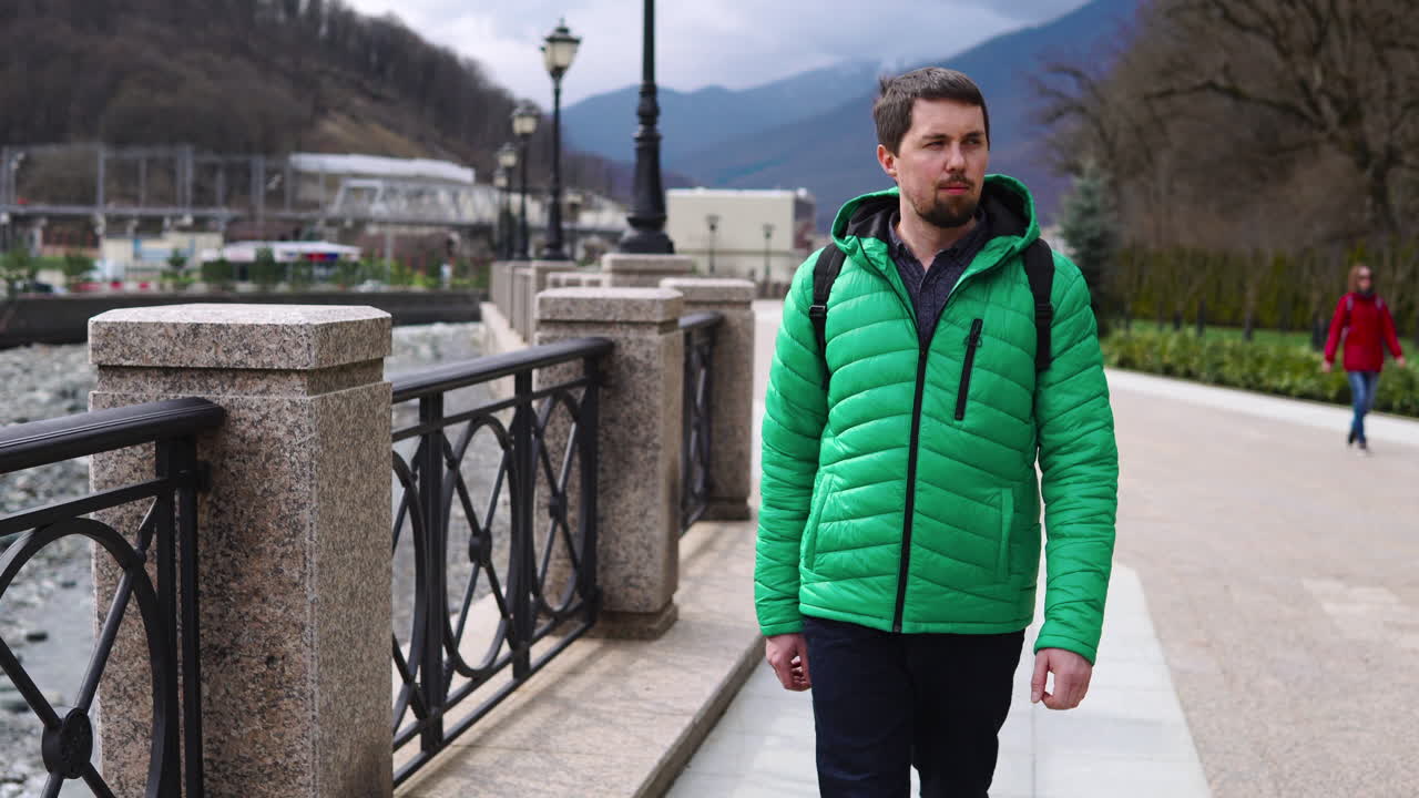 hombre caminando en un parque de la ciudad