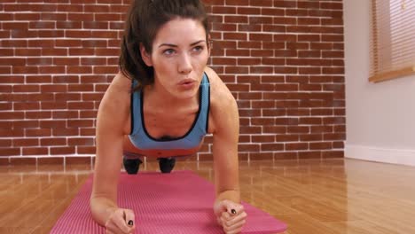 a fit woman on a plank position