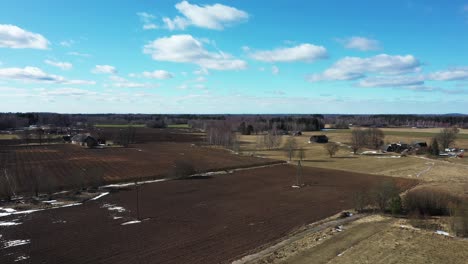 beautiful farmland soil and light blue sky in drone descending shot