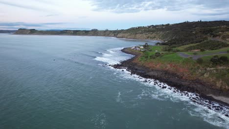 waves on the rugged shore of manu bay reserve in raglan, north island, new zealand