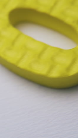 different bright colorful foam rubber numbers lie on clean white background extreme close view