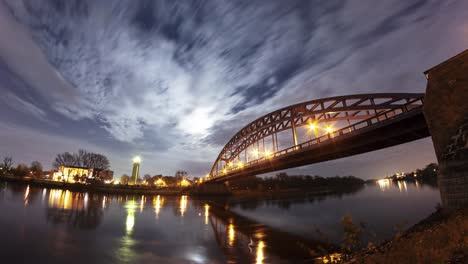 a mesmerizing timelapse of the stern bridge in magdeburg under the full moon, with clouds drifting across the night sky.