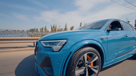 audi fully electric suv in cityy. full electric luxury crossover audi driving in bridge