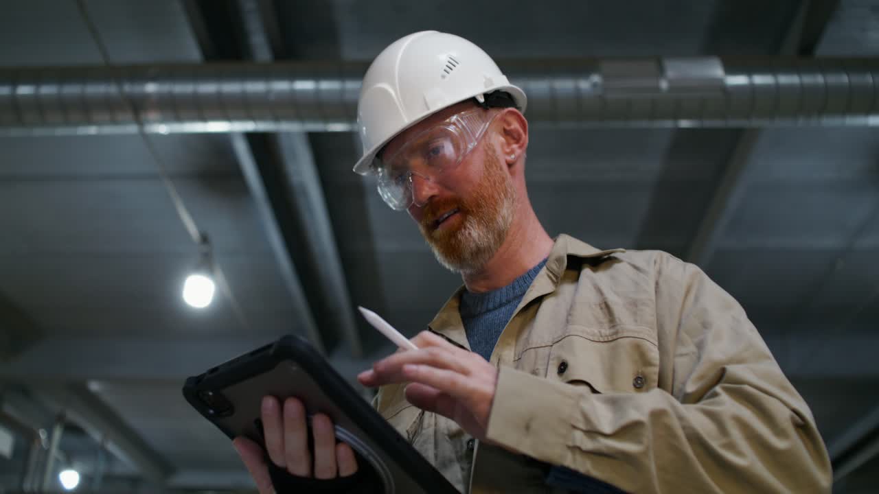 trabajador inspeccionando el equipo con una tableta
