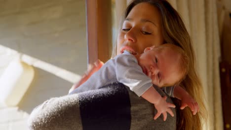 Mother-consoling-her-baby-boy-in-living-room-4k