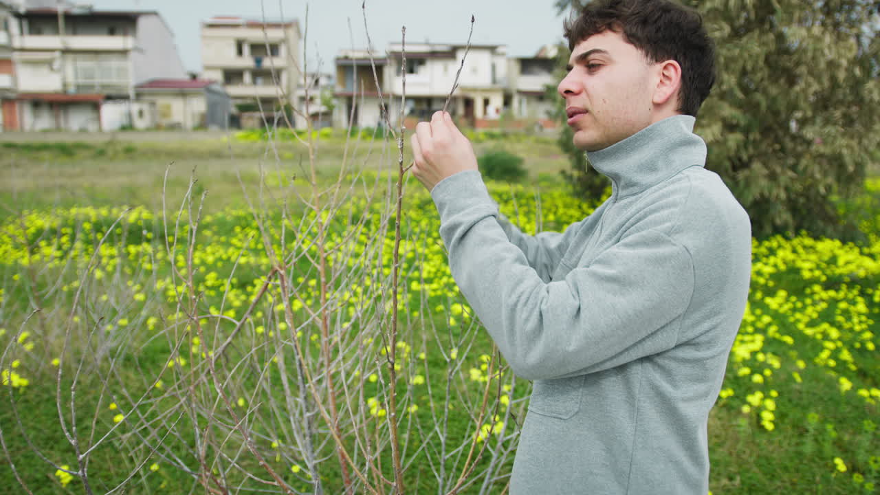 Man Walking In The Nature During Autumn And Looking At Some Bare Tree Branches