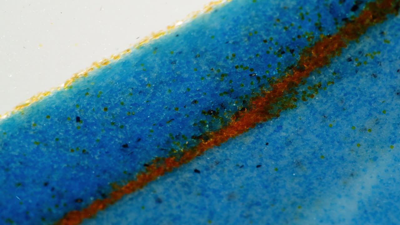 Close-up view of a ceramic surface with blue, orange, and green details