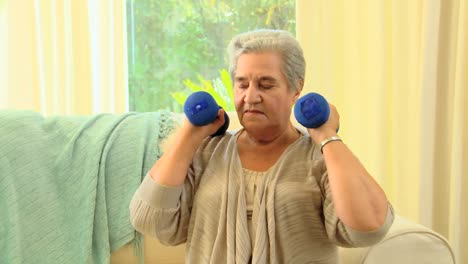 Mature-woman-exercising-using-dumbbells