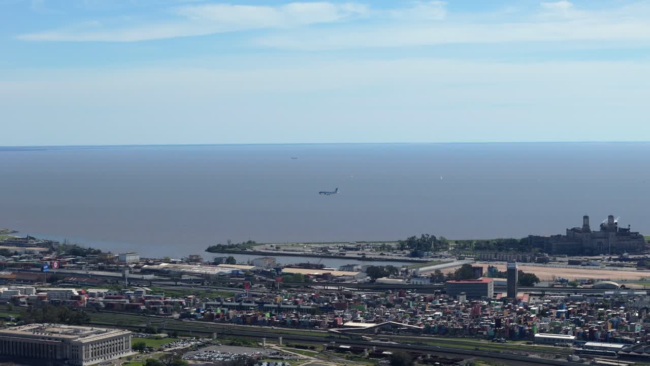 Far shot of an airplane landing on Aeroparque - Buenos Aires with the river in the background, sunny, copy space