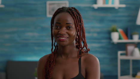 portrait of black woman smiling and looking into camera during fitness morning workout