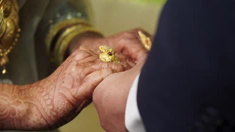 wedding hands with rings and henna