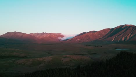 drone dusk rolling clouds over mountain range sunset new zealand