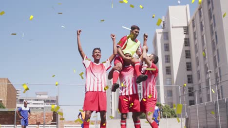 Animation-of-confetti-falling-over-male-football-team-celebrating-on-pitch