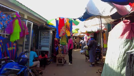 POV walking inside Serekunda market market stalls with textile dress clothing african traditional style
