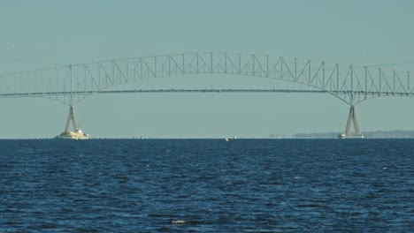 Francis-Scott-Key-Bridge-in-Dundalk,-Baltimore-MD-telephoto-shot-cars-driving-over-the-Patapsco-River