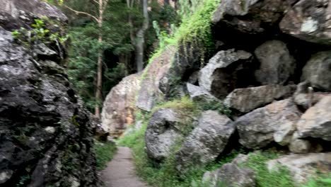 narrow trail winding through rocky terrain and greenery