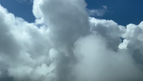 impressive view from a jet cockpit flying at 12000 metres high while penetrating some very high stormy clouds