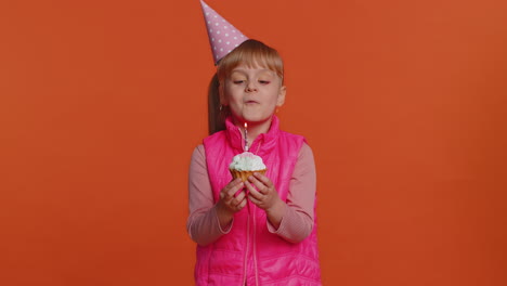 Happy-toddler-children-girl-celebrating-birthday-anniversary-party,-blowing-candle-on-small-cake