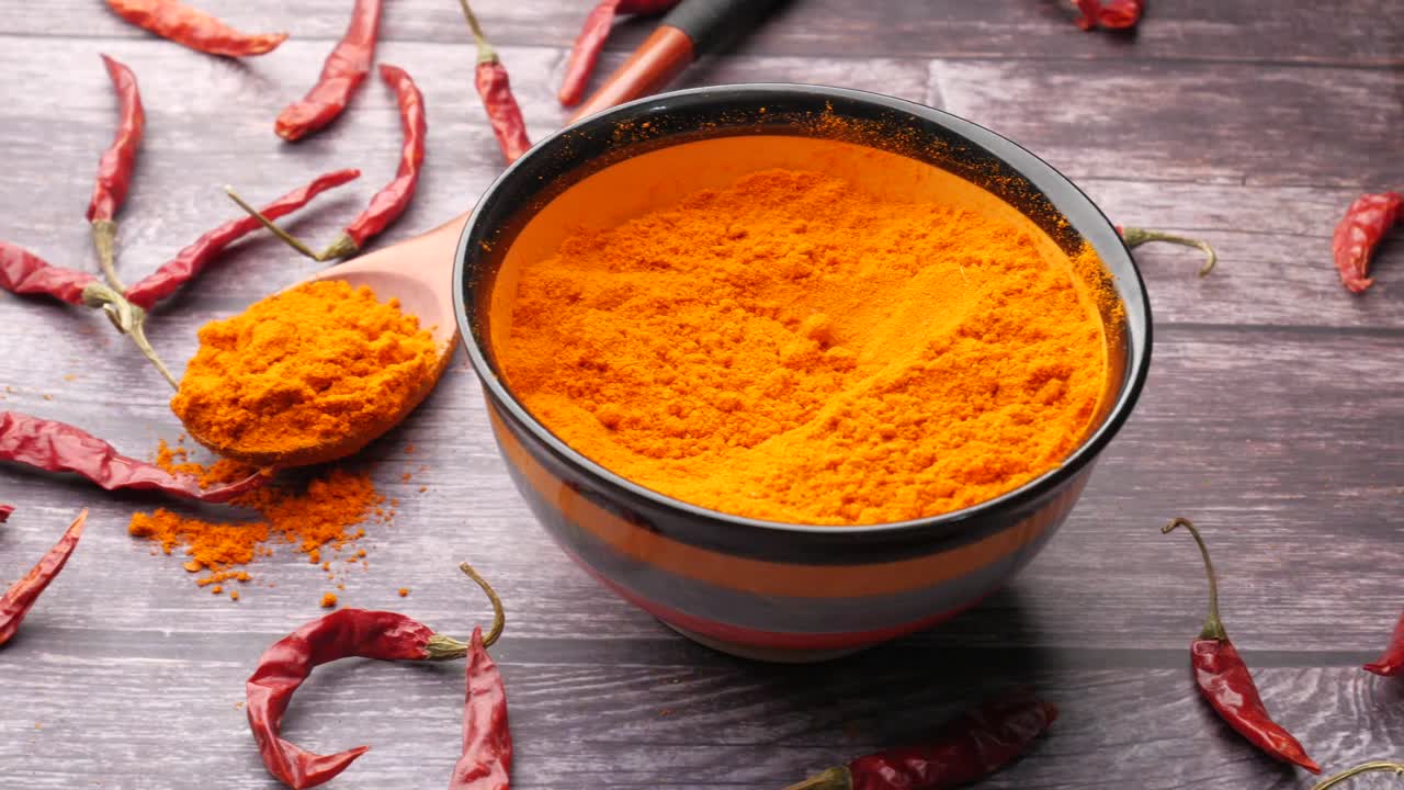 Chili Powder in a Bowl with Dried Chili Peppers