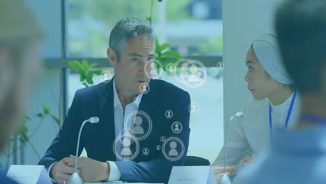 animation of people icons over caucasian businesspeople networking