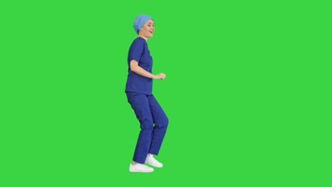 girl doctor is dancing and walking on a green screen, chroma key