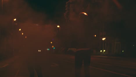 teenagers running down city street with smoke flares at night