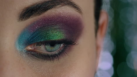 close up beautiful woman eye wearing colorful makeup cosmetics evening nightlife concept