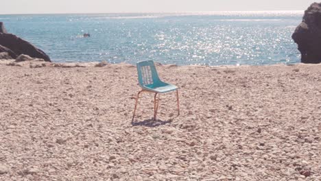 lonely chair on a pebble beach