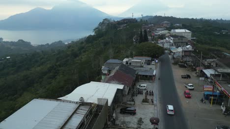 Aerial-orbits-buildings-perched-on-steep-tropical-slope-in-cloudy-Bali