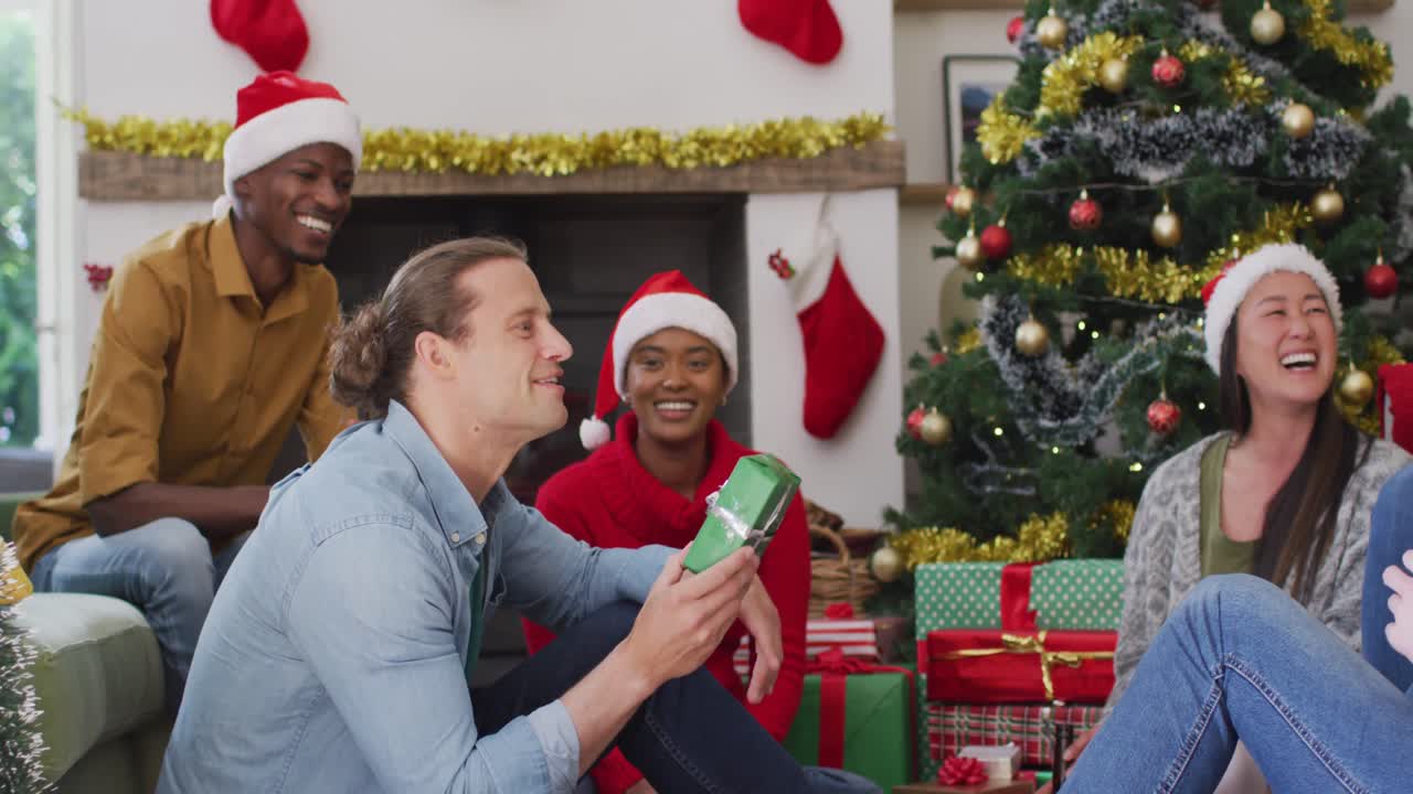 un grupo feliz y diverso de amigos compartiendo regalos en la época de navidad